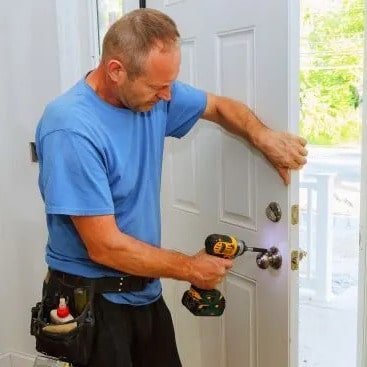 Contractor installs door.