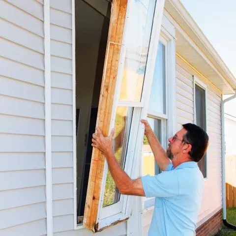 Contractor installs window.