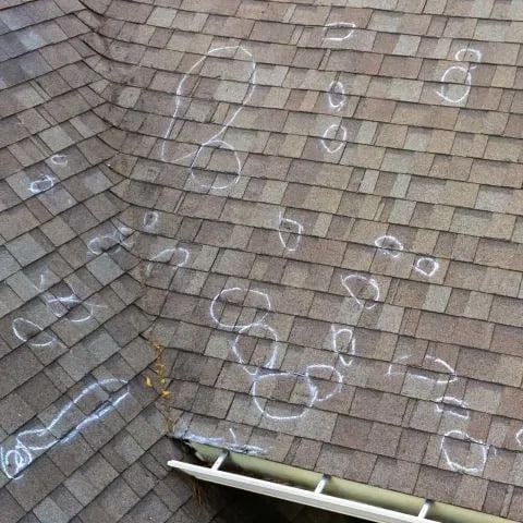 Roof hail damage marked in chalk